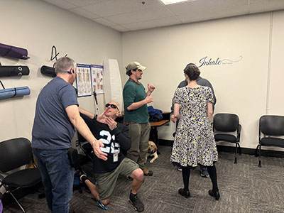 group practicing self defense techniques as coach watches