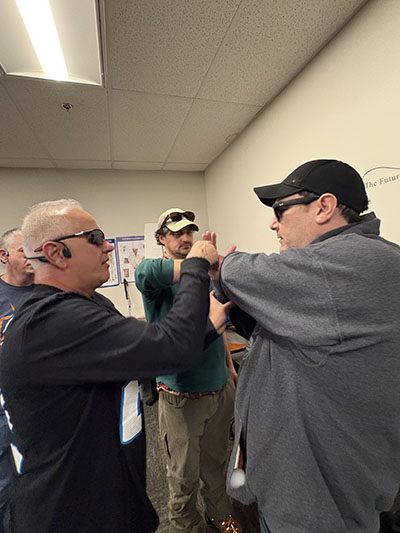 3 students practicing self defense techniques